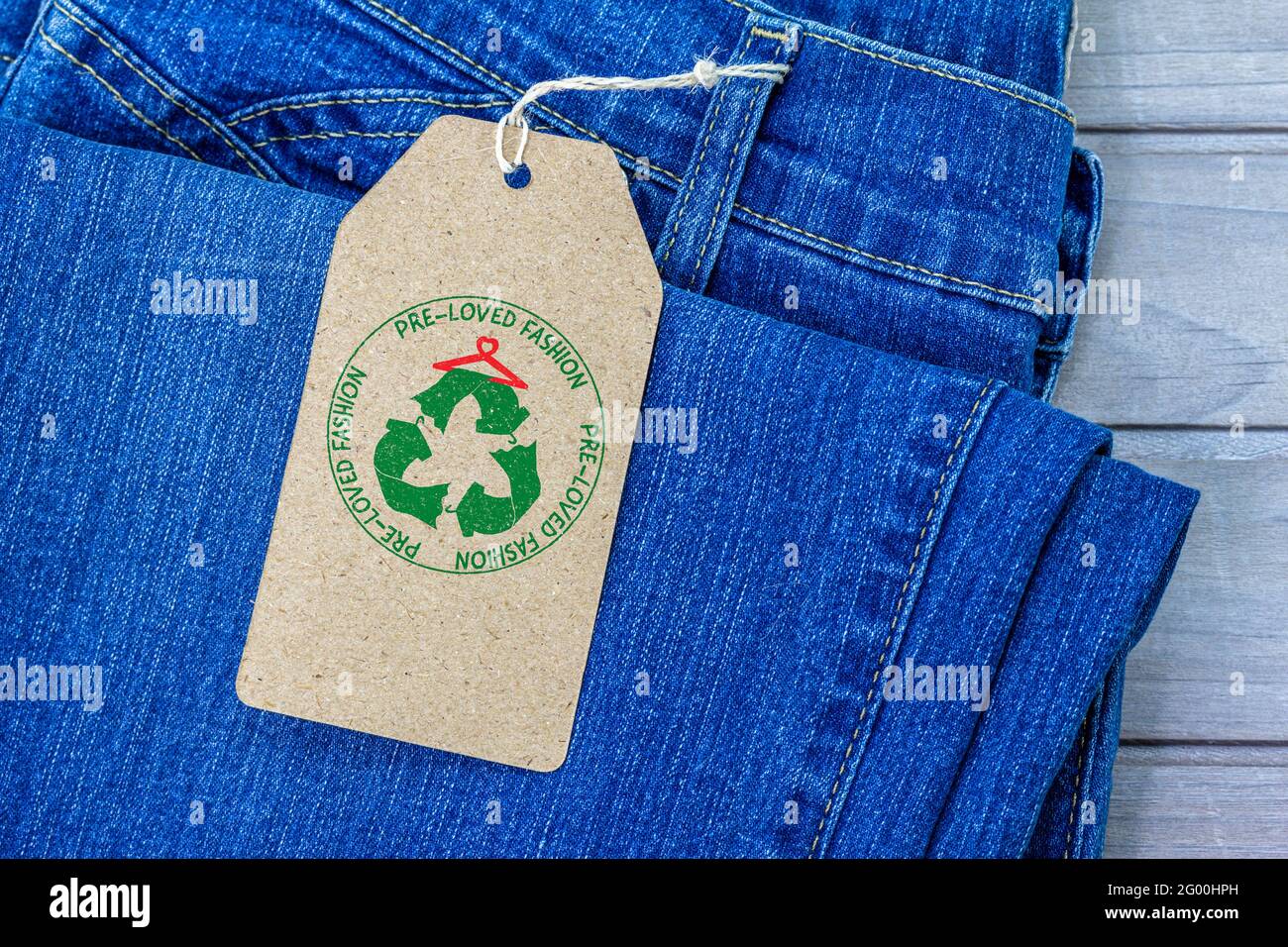 pre loved fashion label on second hand jeans, sustainable fashion Stock Photo