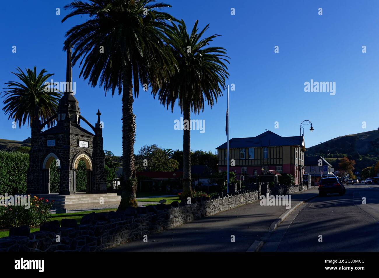 Akaroa's main street, with the War Memorial on the left Stock Photo