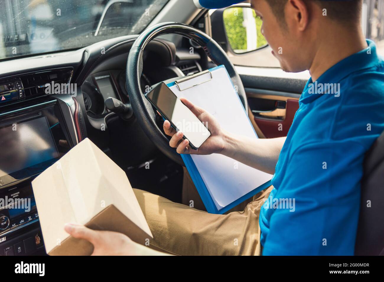 Asian delivery man courier online holding deliveries out boxes inside