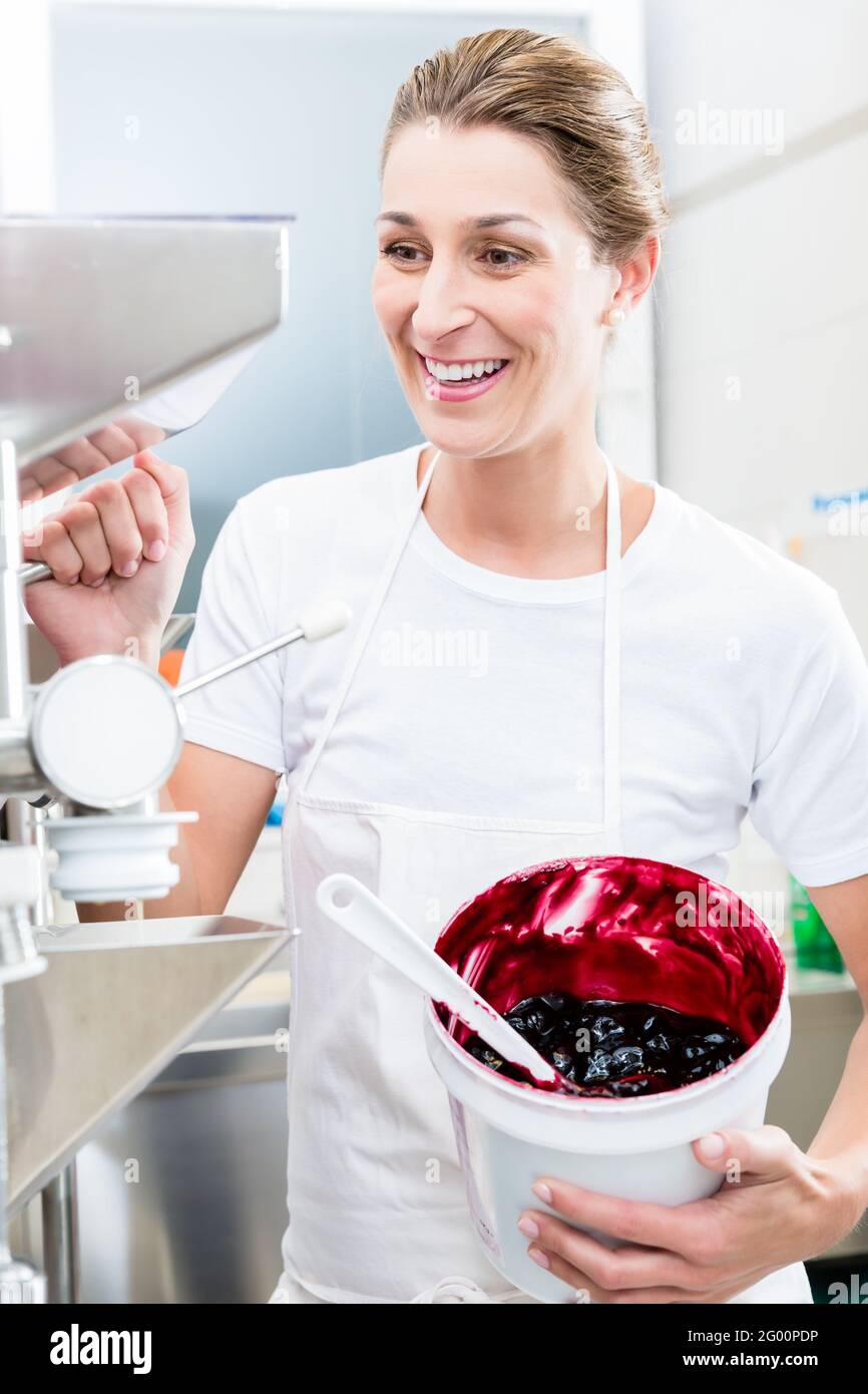 Ice cream maker in her shop at the machine Stock Photo