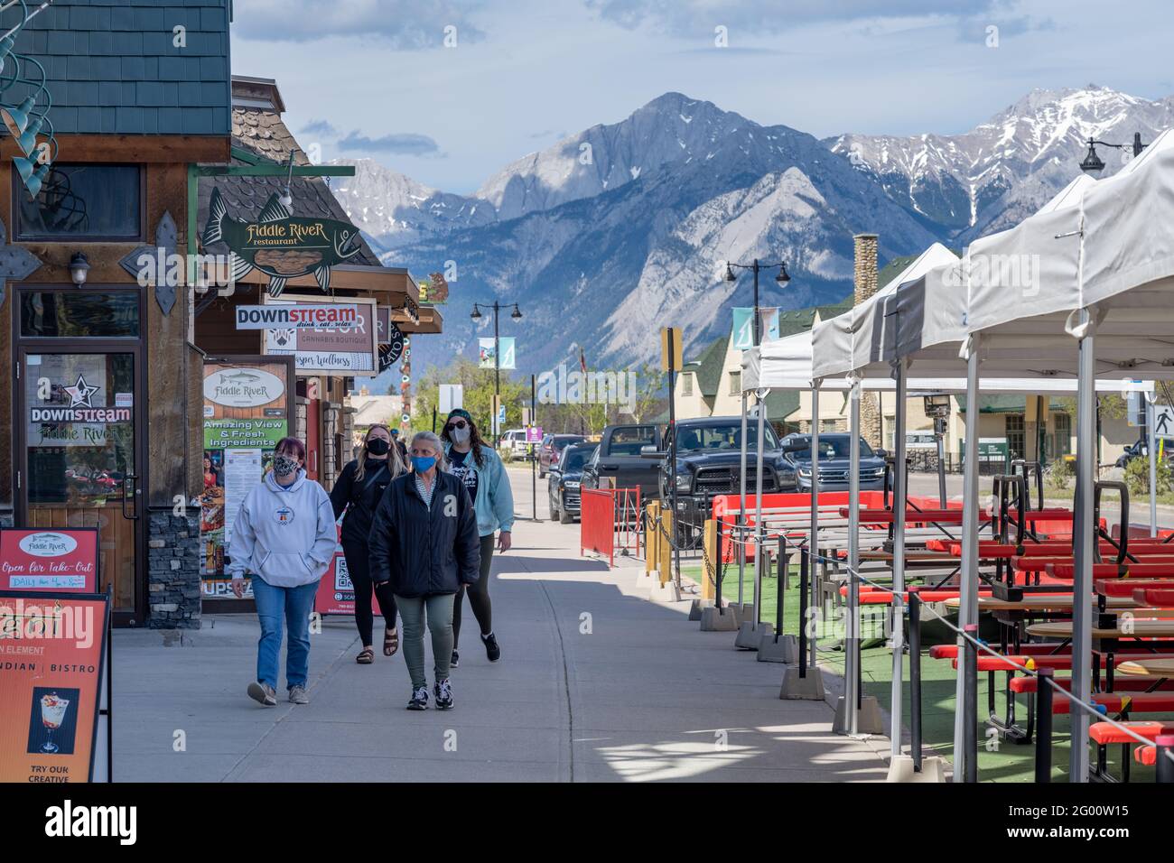 Street view of Town Jasper in summer time season during covid-20 pandemic period, people are wearing face masks. Jasper, Alberta, Canada. Stock Photo