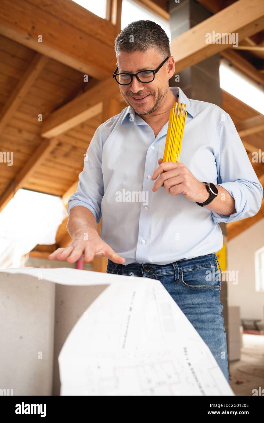 man with black glasses and blue shirt 