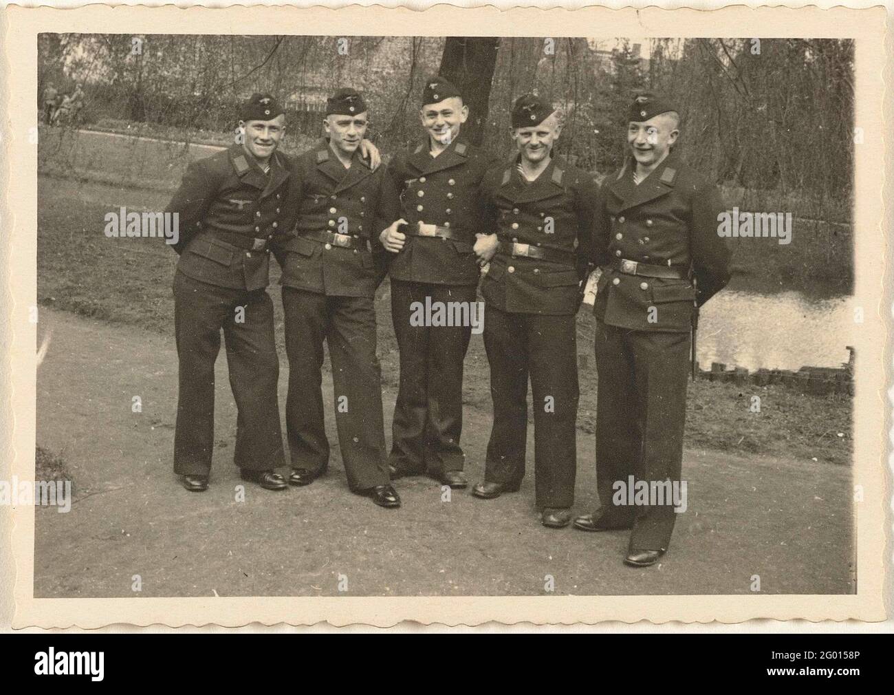 five-sailors-in-a-park-five-sailors-in-uniform-in-a-park-a-pond