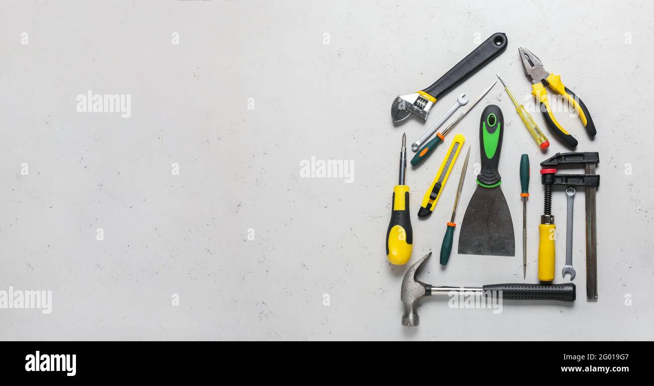 House shape made with construction tools on light background with space for text Stock Photo