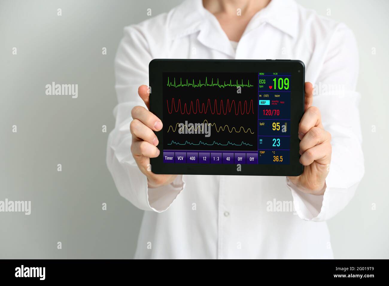 Doctor with heart rate monitor on screen of tablet computer against ...