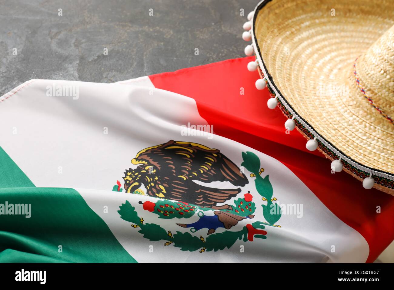 Mexican flag and sombrero hat on dark 