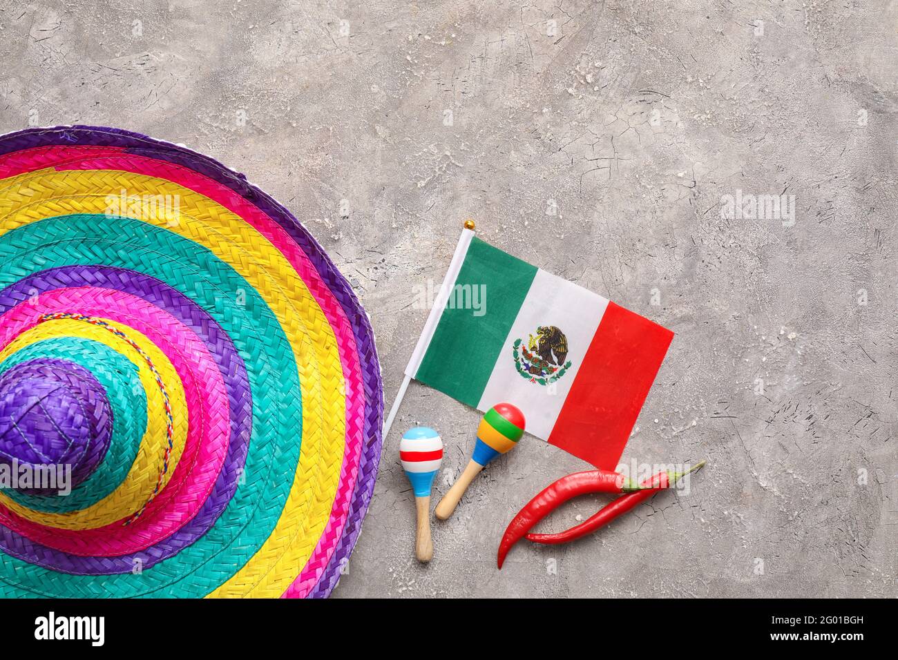Mexican flag, sombrero hat, maracas and chili peppers on grey ...