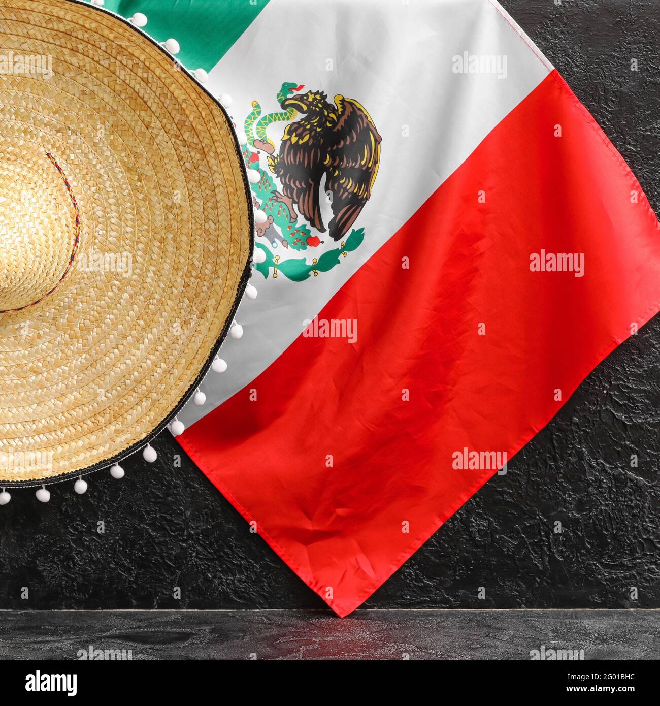 Mexican flag and sombrero hat on dark 