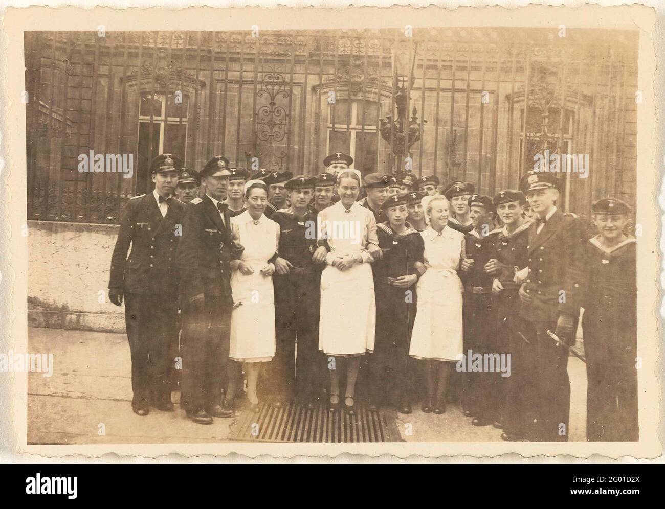 Sailors and three nurses in Paris. Group of sailors in uniform and three nurses posing for a fence in Paris, early May 1943. Four of the Marines are in front of their squat. Part of the Loose Photos group associated with the photo album over the Kriegsmarine 1940-1943. Stock Photo