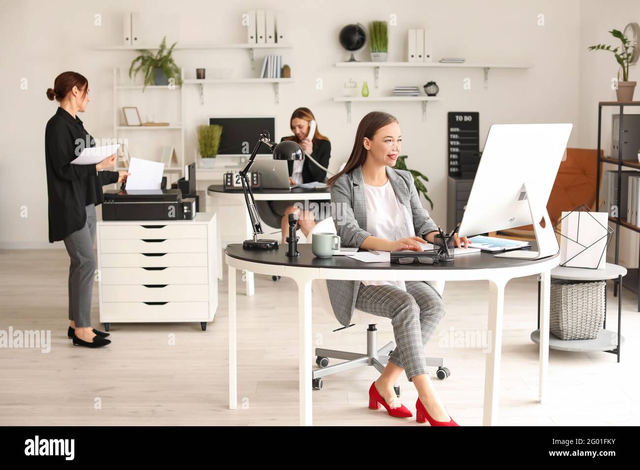 Female accountant working in office Stock Photo - Alamy