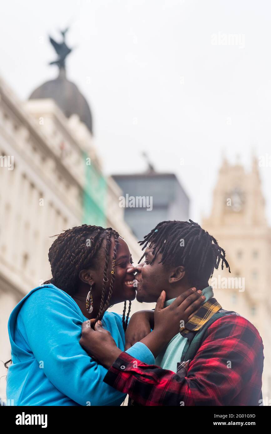 Black couple in love, in the city. Kissing. Stock Photo