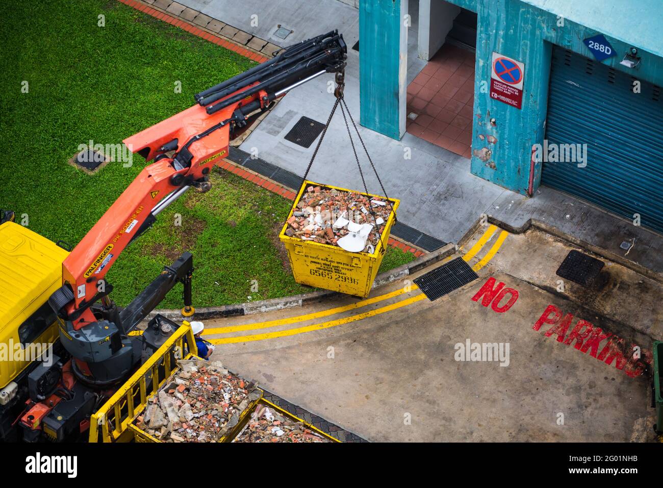 Aerial view of the crane truck lift up heavy debris onto the truck. Stock Photo