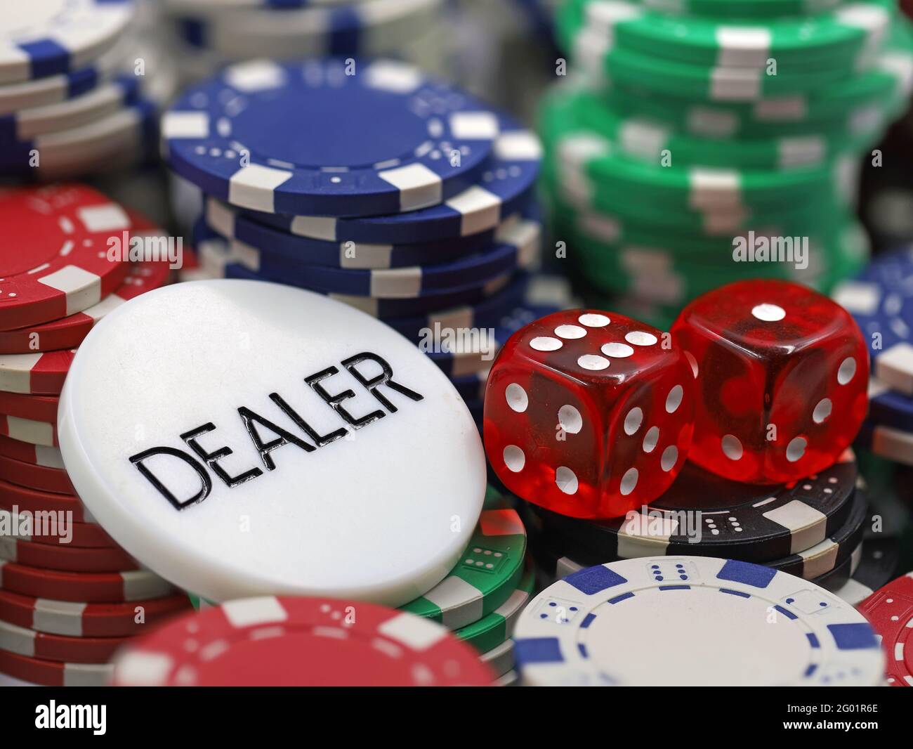 dealer chip with red dices on stacked poker chips, close up Stock Photo -  Alamy
