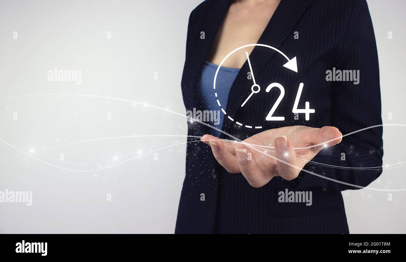 Full time service concept. Hand hold digital hologram 24 all day all night icon on grey background. Technical Support Center Customer Service. Stock Photo