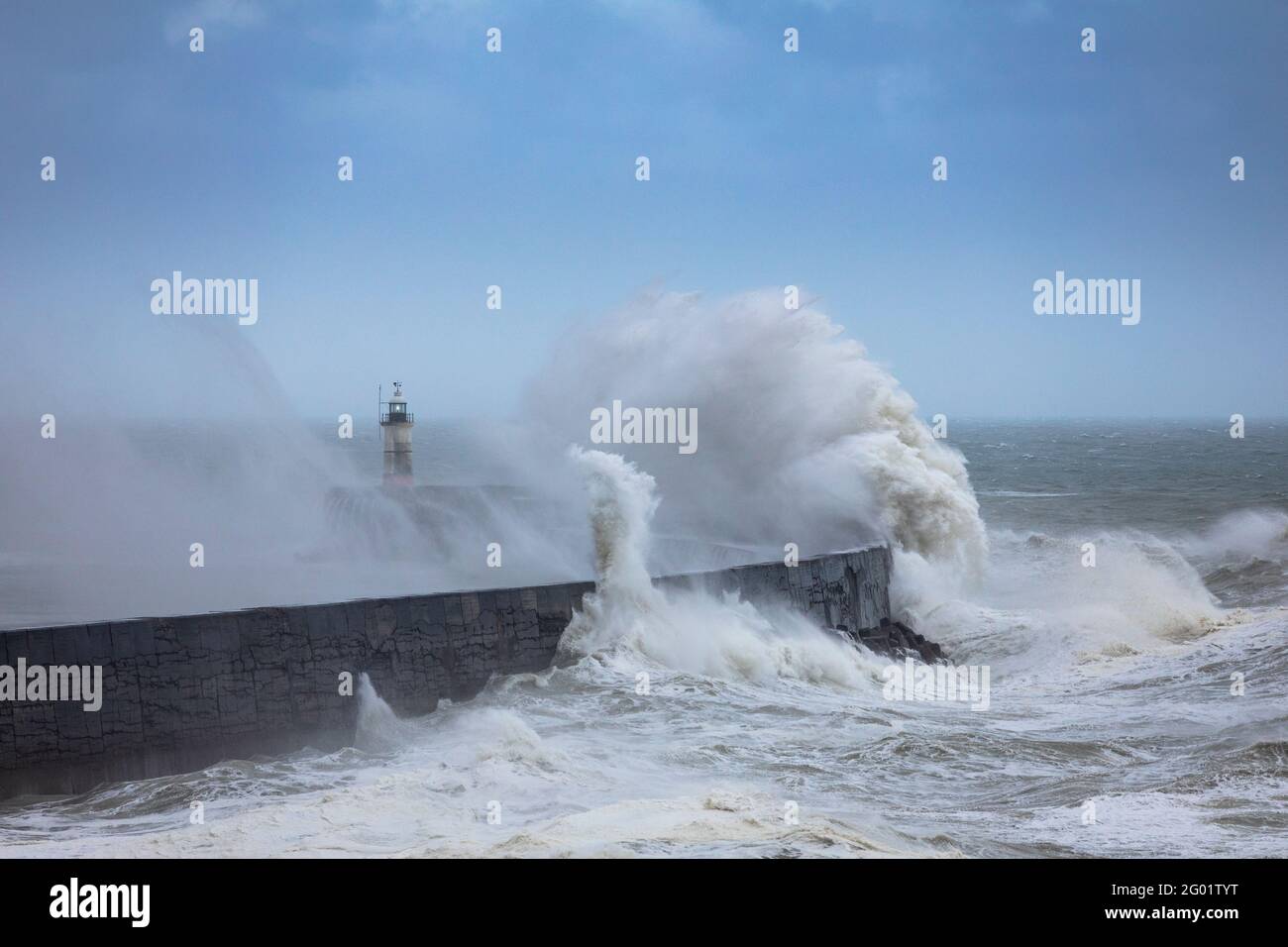 Crashing waves and stormy waters at Newhaven Lighthouse East Sussex, south east England Stock Photo