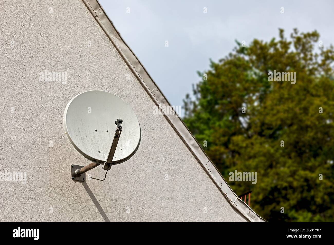 small satellite dish on a house wall Stock Photo