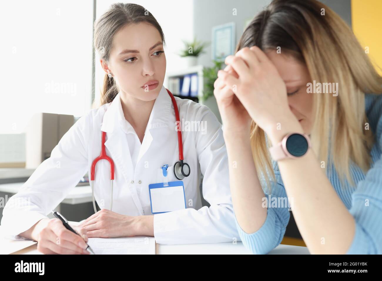 Upset and depressed woman at doctor appointment Stock Photo