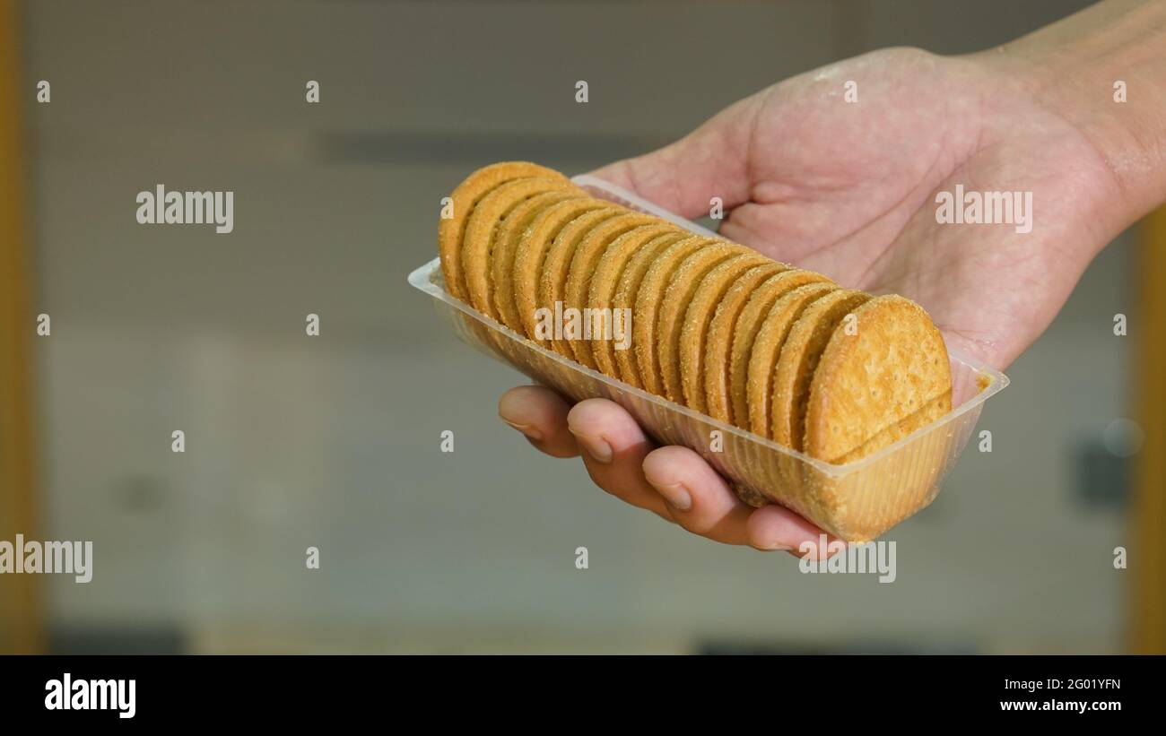 Hand holding a pack of biscuit Stock Photo