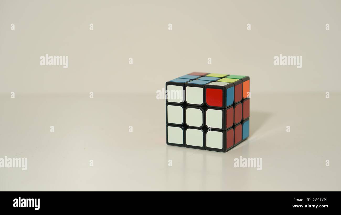 Unsolved Rubik's Cube on White Background Stock Photo