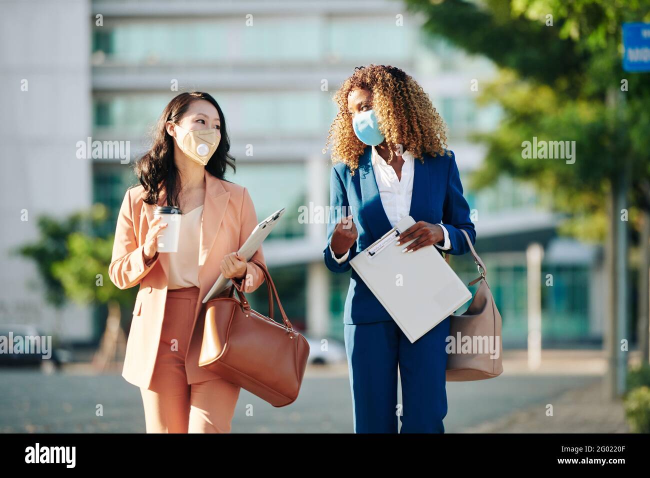 Asian female office worker walking hi-res stock photography and images