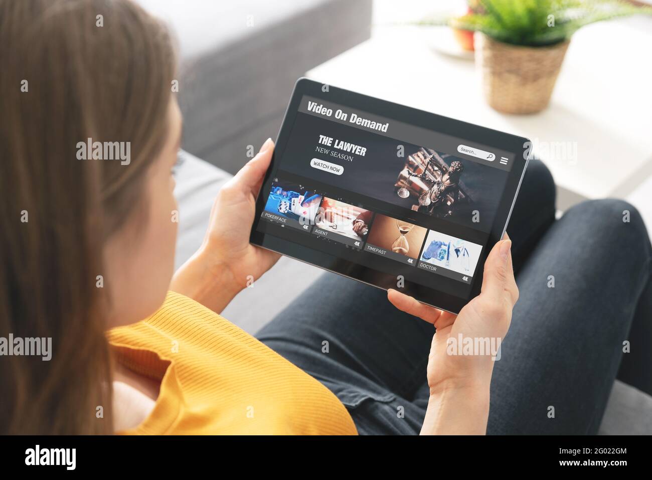 Video on demand, movie streaming, woman with tablet using video service Stock Photo