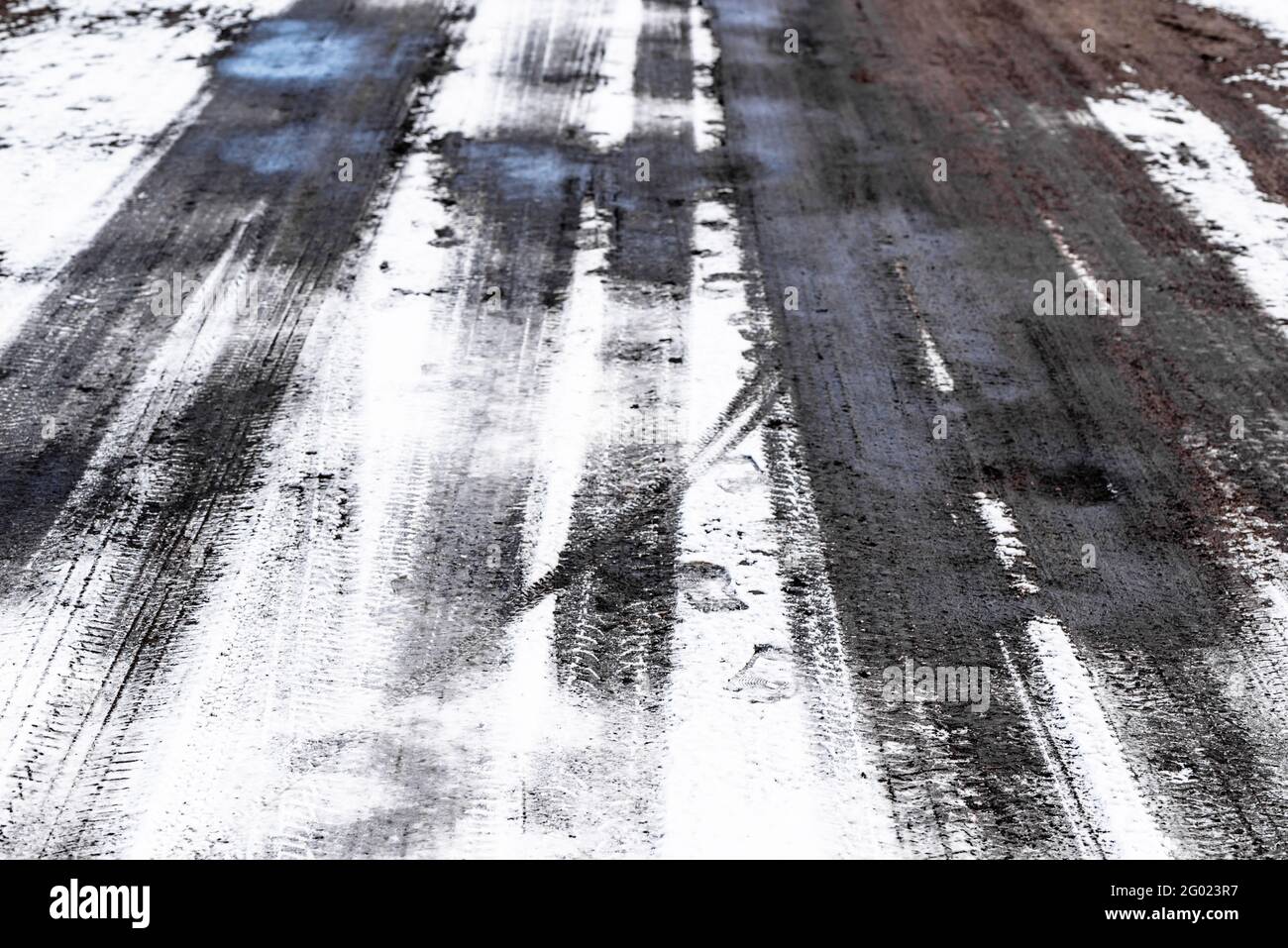 Snow on road with tire tracks, winter texture Stock Photo - Alamy