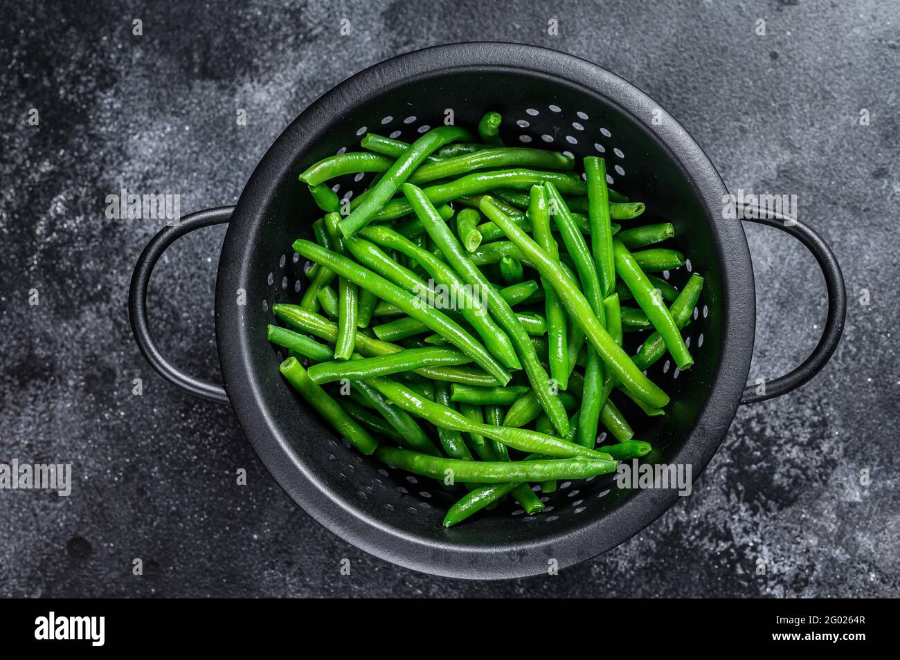 Raw green beans in a colander. Black background. top view Stock Photo ...