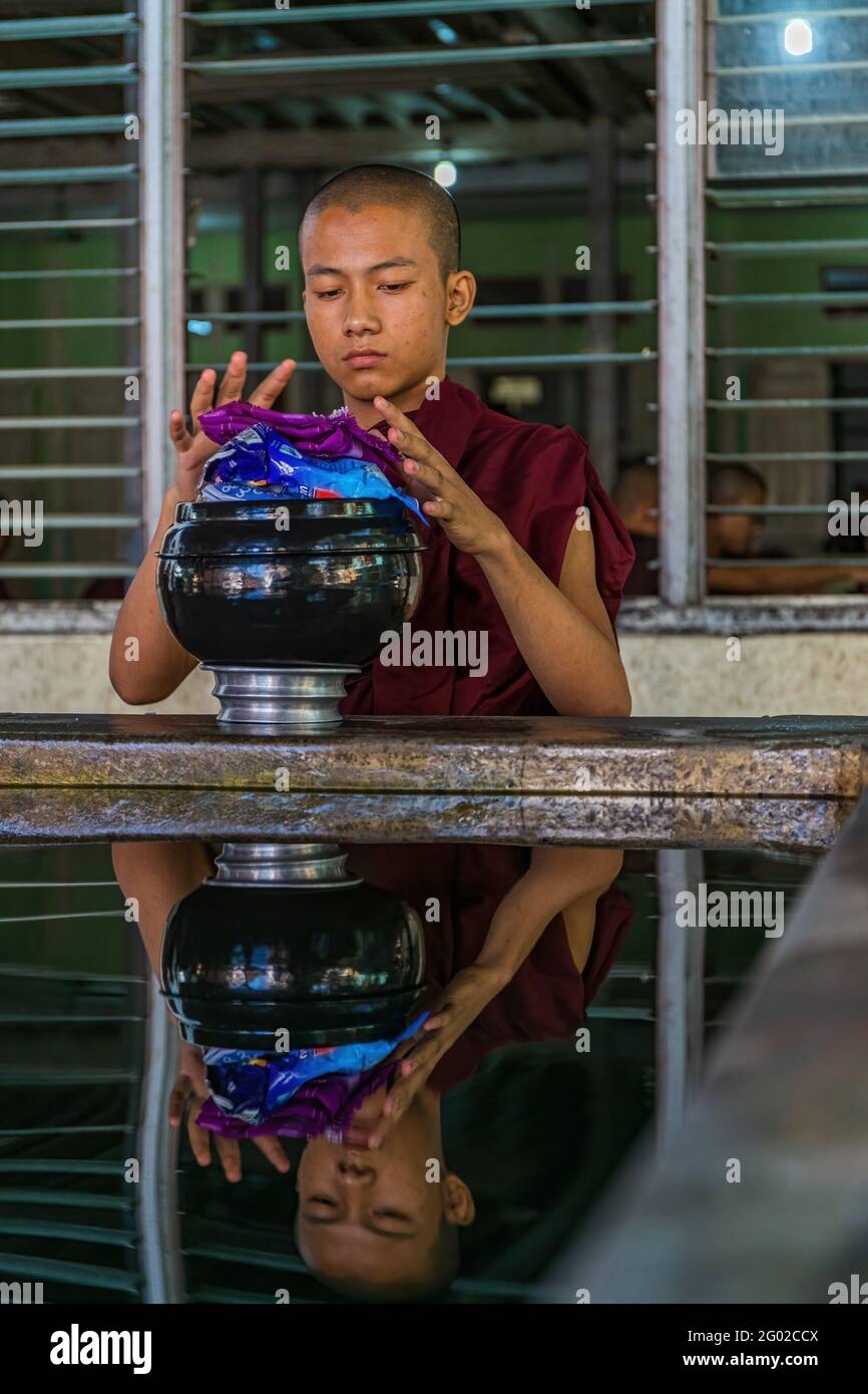 MANDALAY, MYANMAR - DEC 30, 2017: Monk with traditional bowl at Mahagandayon Monastery , Myanmar Stock Photo