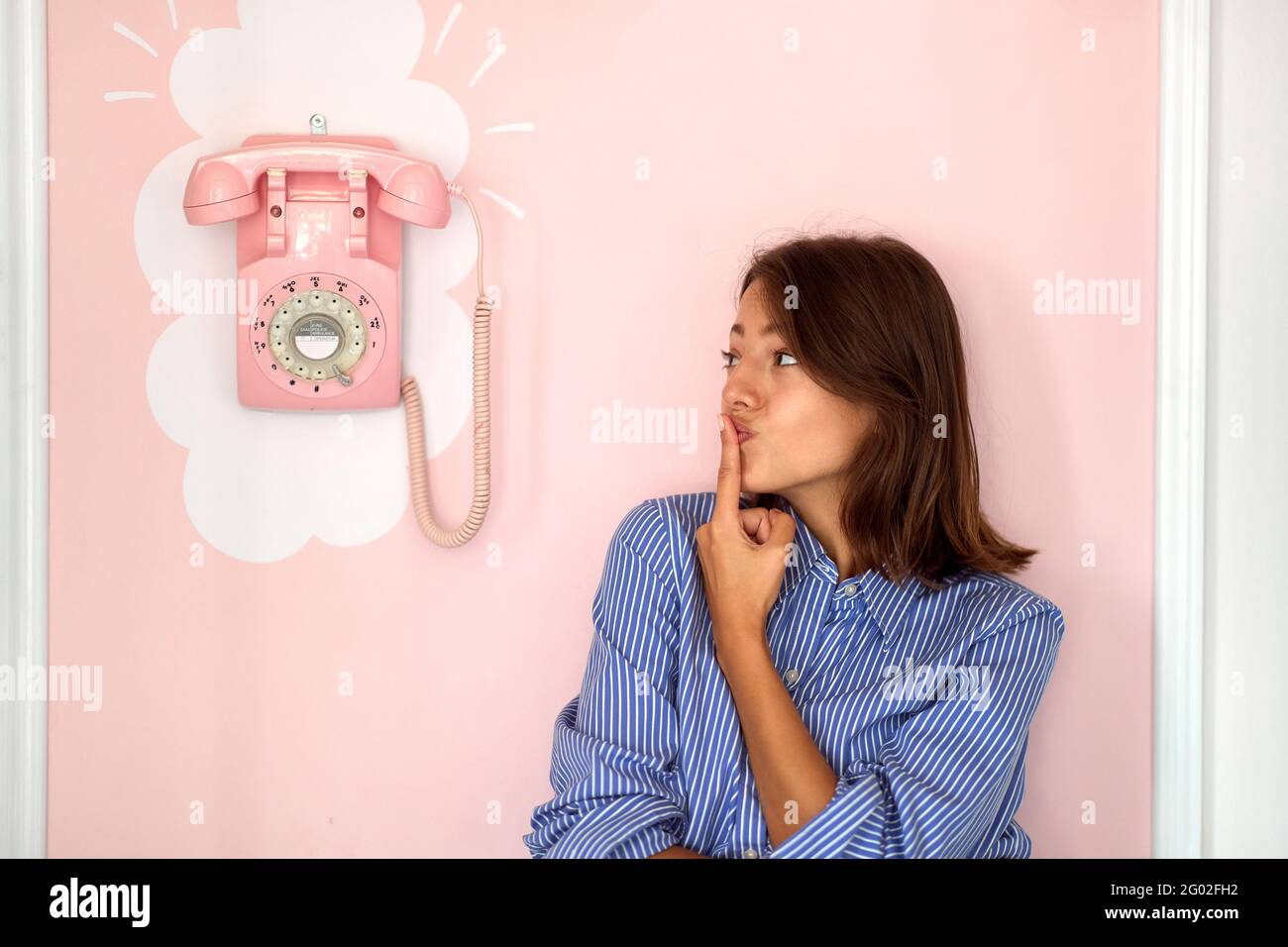 Lovely brunette isolated on a retro pink background Stock Photo