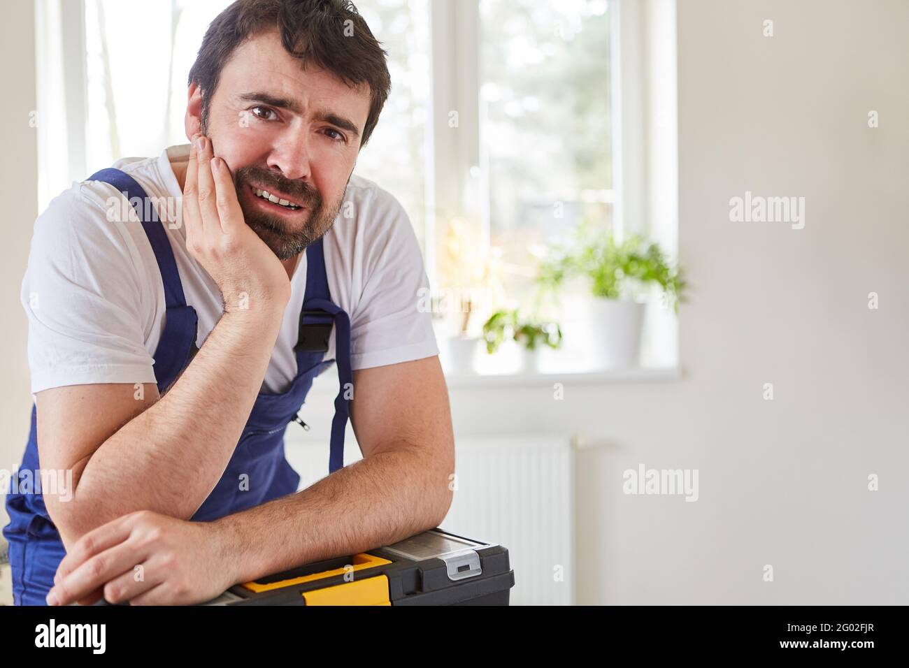 Do-it-yourselfers or craftsmen from the repair service in an apartment with a toolbox Stock Photo