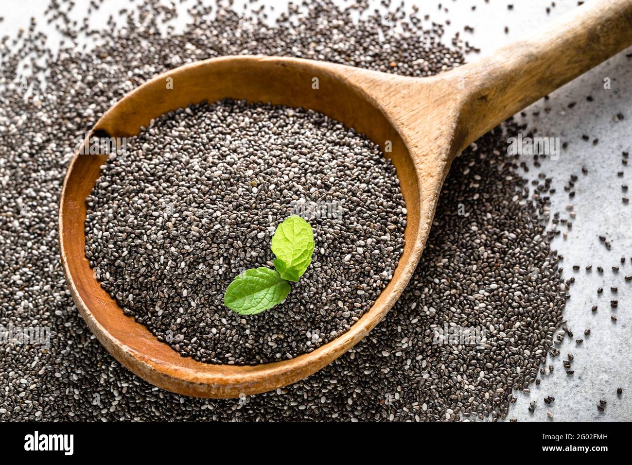 Healthy food, sources omega3 chia seed, closeup on wooden spoon