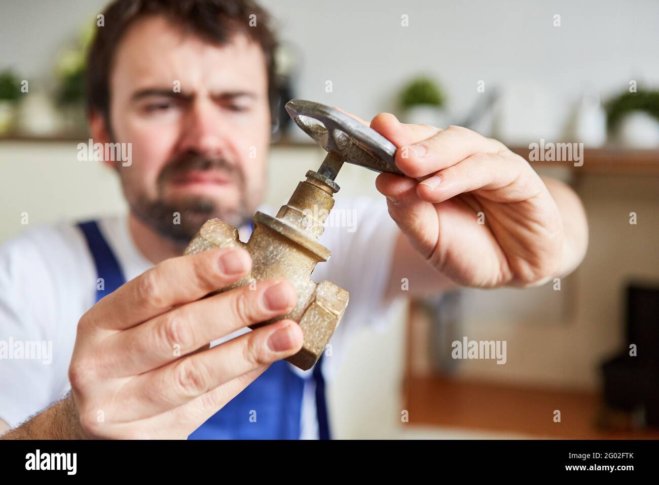 Do-it-yourselfer keeps a new shut-off valve as a spare part for the defective kitchen sink Stock Photo