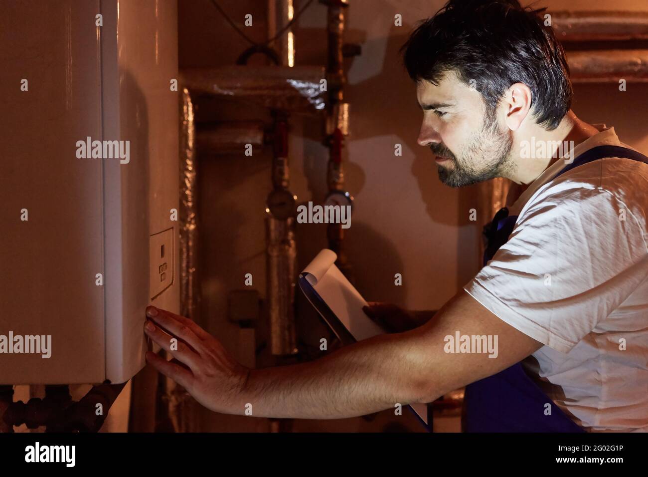 Installer or heating technician with checklist checks gas heating