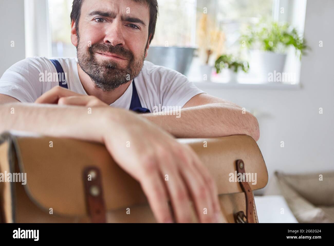 Helpless do-it-yourselfer or stressed craftsman because of botch-up or overtime Stock Photo