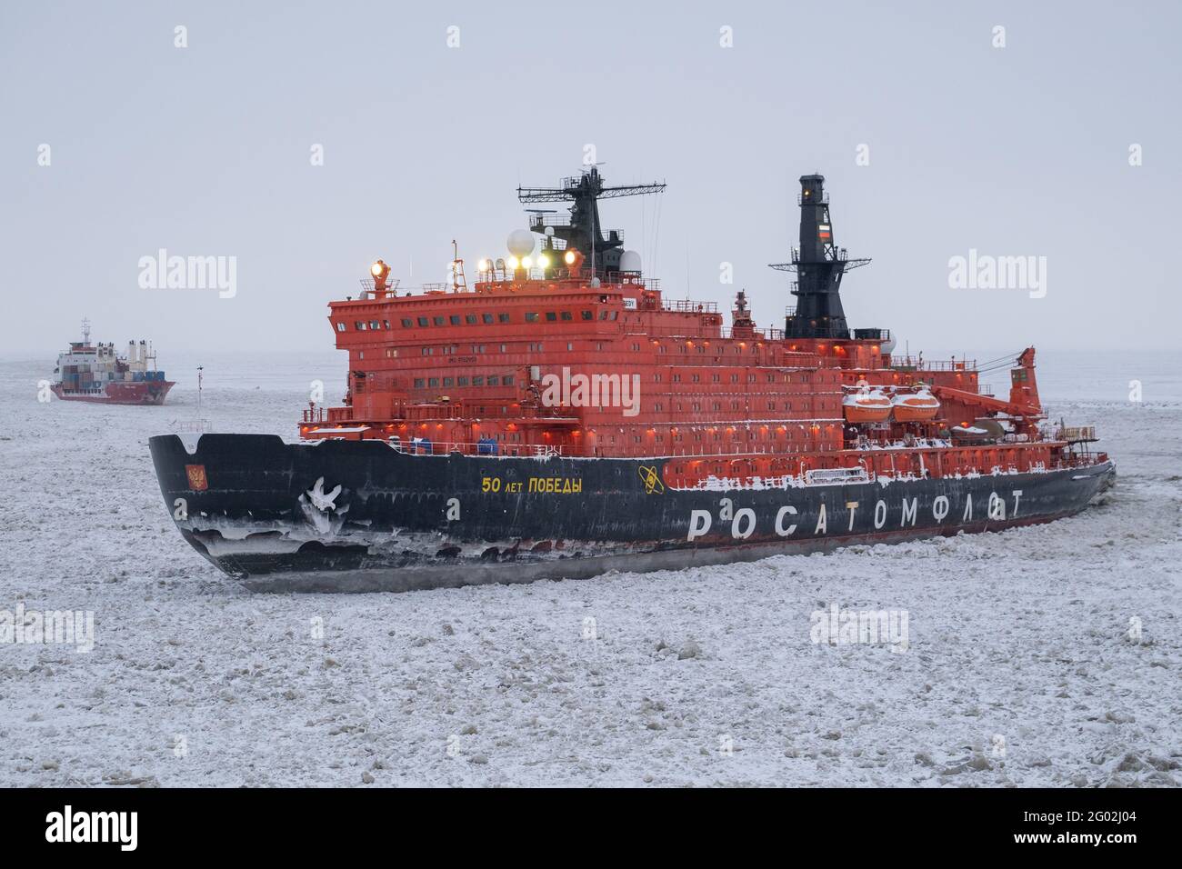 Sabetta, Tyumen region, Russia - April 4, 2021: The 50 let Pobedy icebreaker moves into ices. Overcast, light snow is falling. Stock Photo