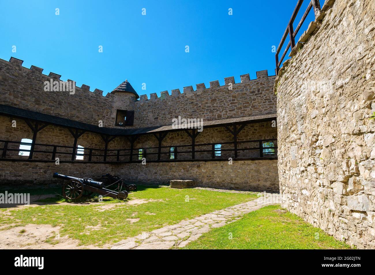 Stara Lubovna, Slovakia - 28 AUG 2016: ancient cannon in the inner courtyard of the castle. great stone walls of a fortrece. popular travel destinatio Stock Photo