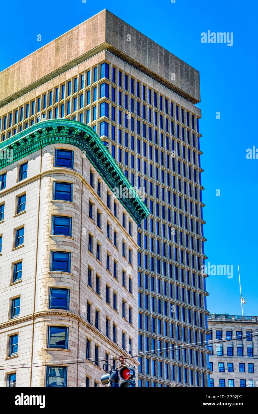 Looking up: Curved SE corner of the Banigan (aka Amica) Building against the concrete grid of the Old Stone Tower in the Financial District. Stock Photo