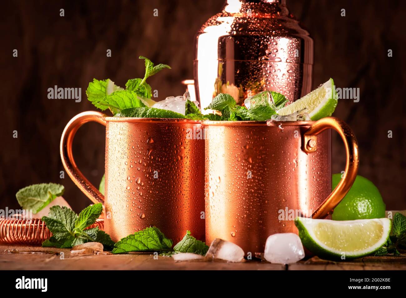 Moscow mule or mint julep alcoholic cocktail in copper mug with lime, ginger beer, vodka and