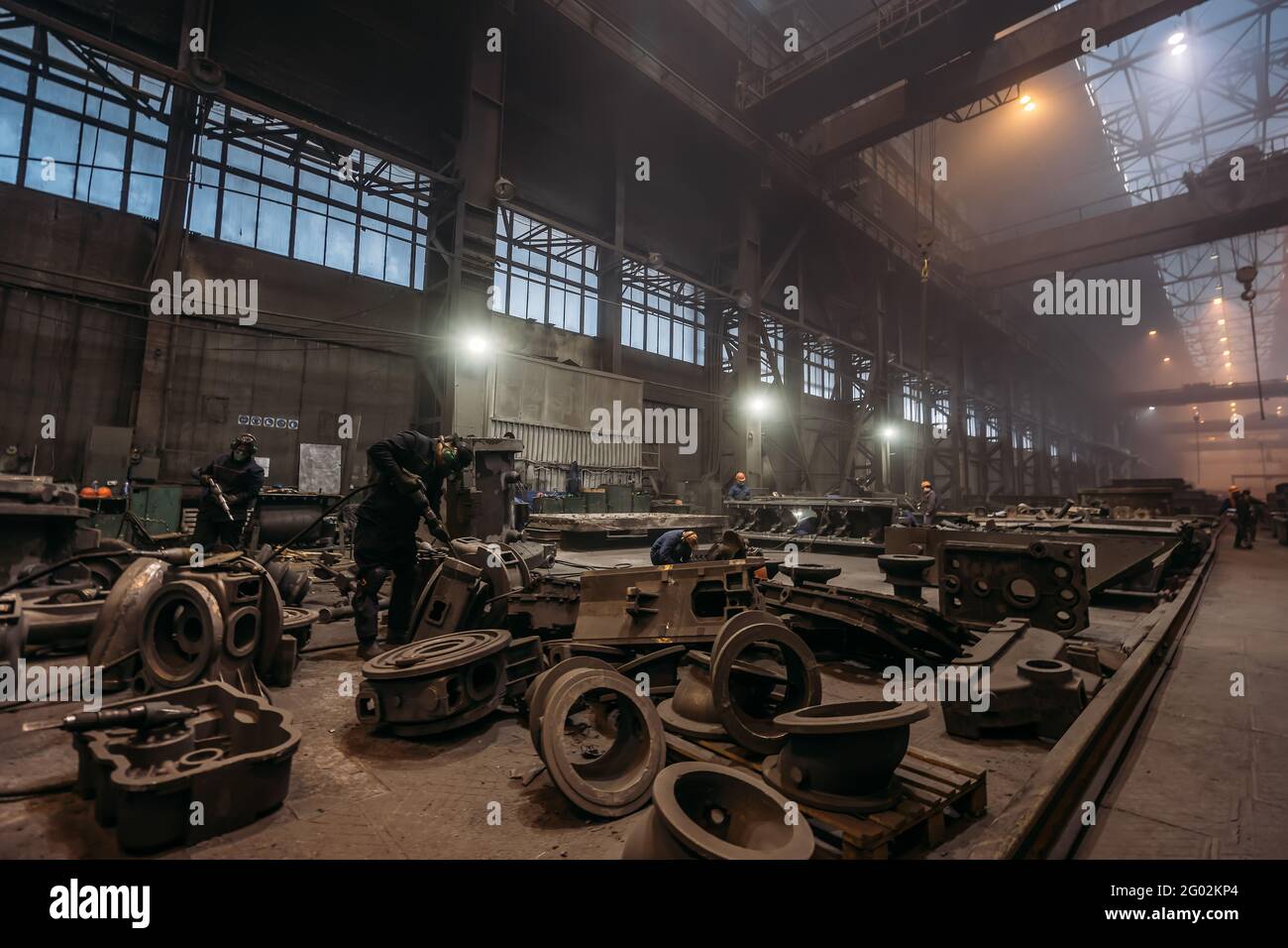 Large workshop interior for metalworking of finished cast metal products at metallurgical plant of heavy industry. Stock Photo