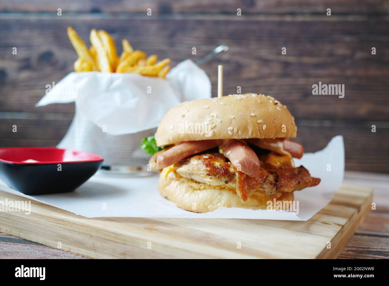 sausage beef burger and potato chips on table Stock Photo Alamy