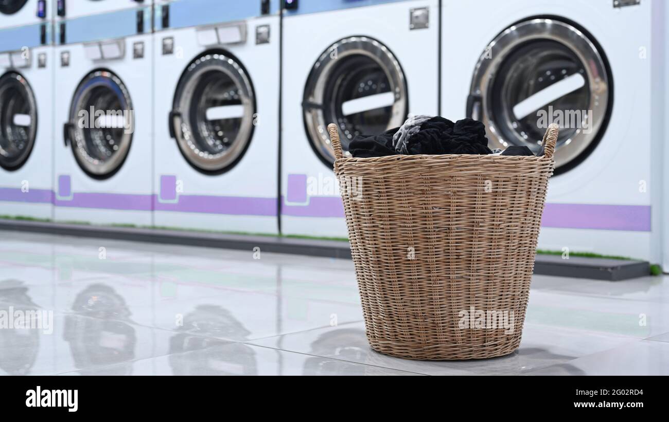 A basket of laundry and public laundromat Stock Photo Alamy