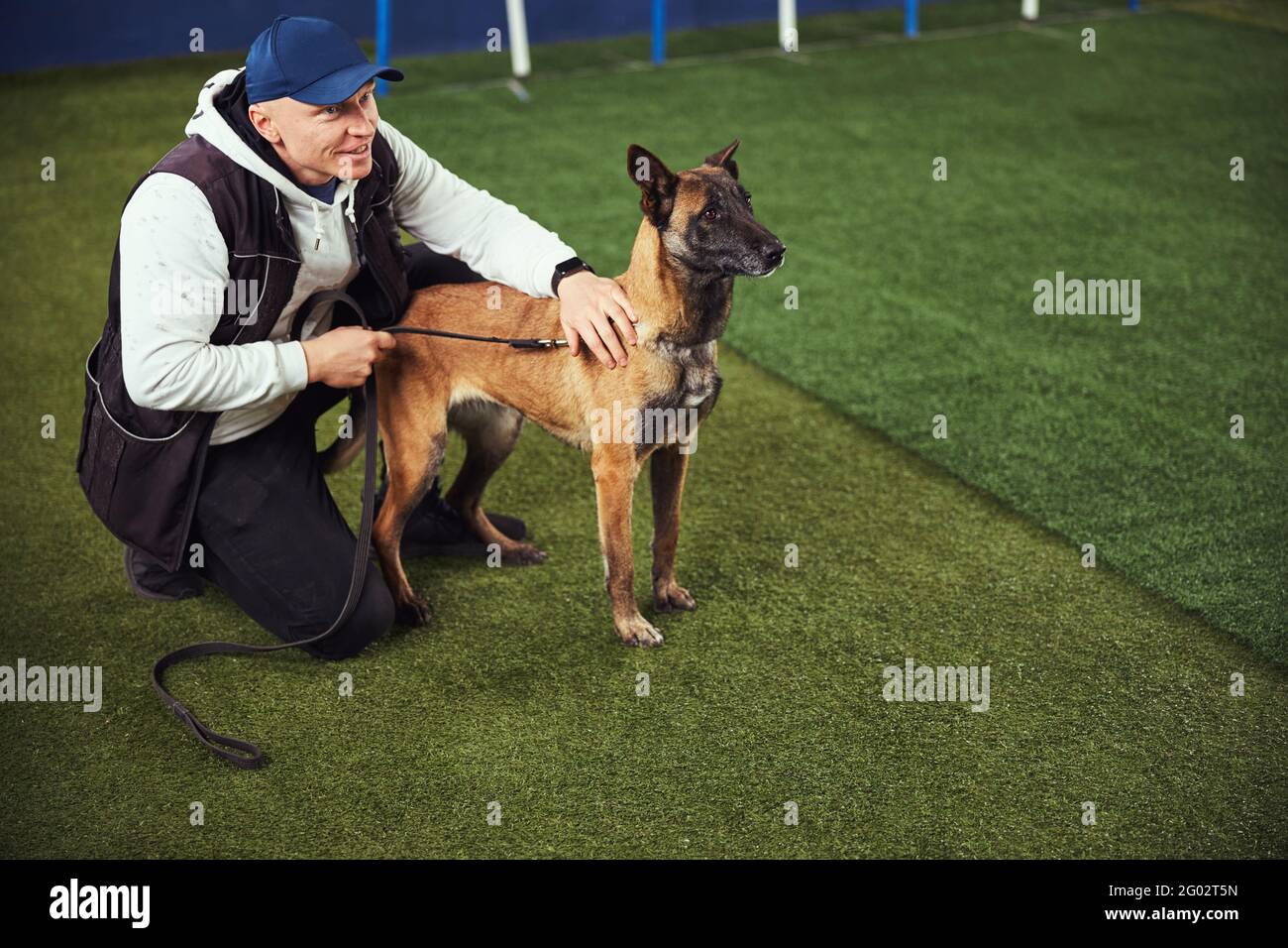 Contented trainer and a Belgian Malinois in the obedience school