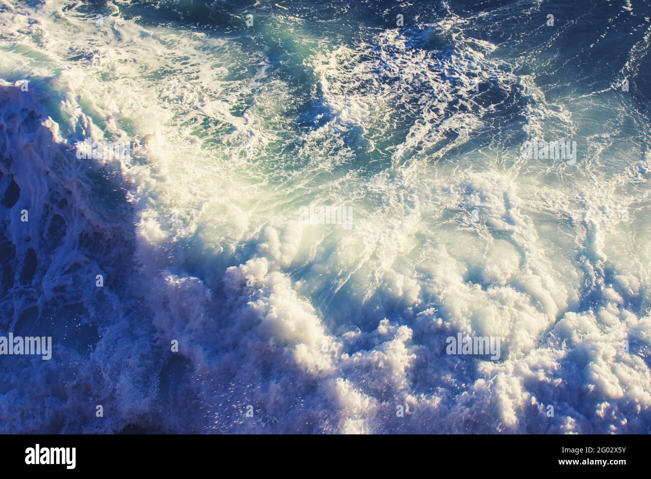 Sea waves crashing on the shore. Top view. Concept of power of nature. Stock Photo