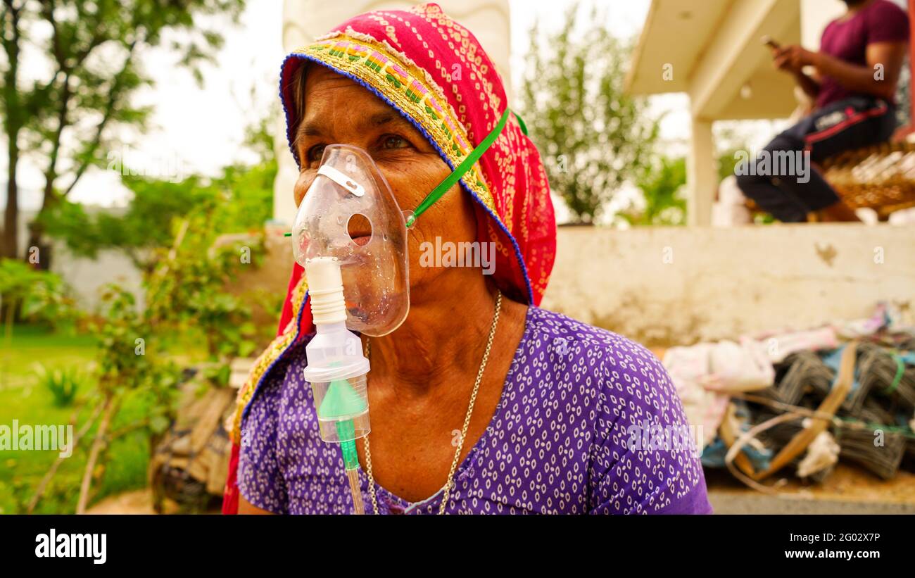 20 May 2021- Reengus, Sikar, India. Concept outside hospital quarantine, prevention COVID-19 or Coronavirus outbreak situation. Old Indian woman suffe Stock Photo