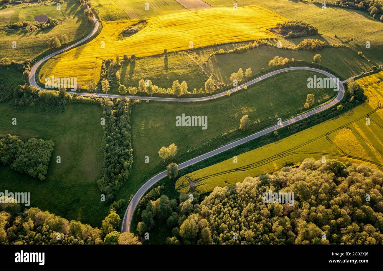 Aerial view of a curvy road through the Masurian landscape at the sunset Stock Photo