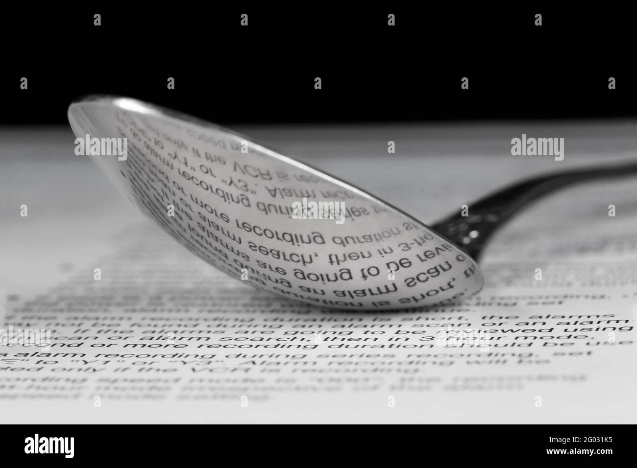 Reflection of printed text on the back of a steel spoon Stock Photo