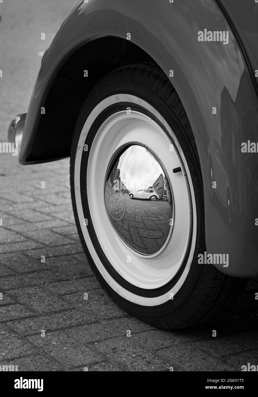 ZOETERMEER, NETHERLANDS - May 20, 2021: Retro car Volkswagen Beetle black and white shot of a rear wheel with a reflection of a VW Beetle in it. Stock Photo