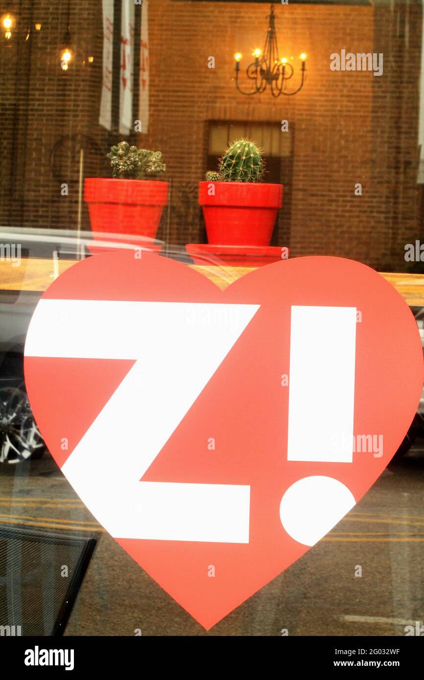 Downtown Zeeland, MI, USA. Storefront window displaying the city slogan