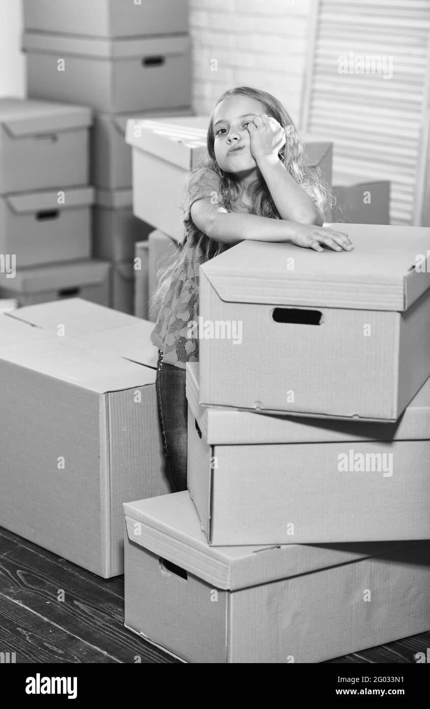Unreal Service. purchase of new habitation. happy little girl. Moving concept. new apartment. happy child cardboard box. Cardboard boxes - moving to Stock Photo