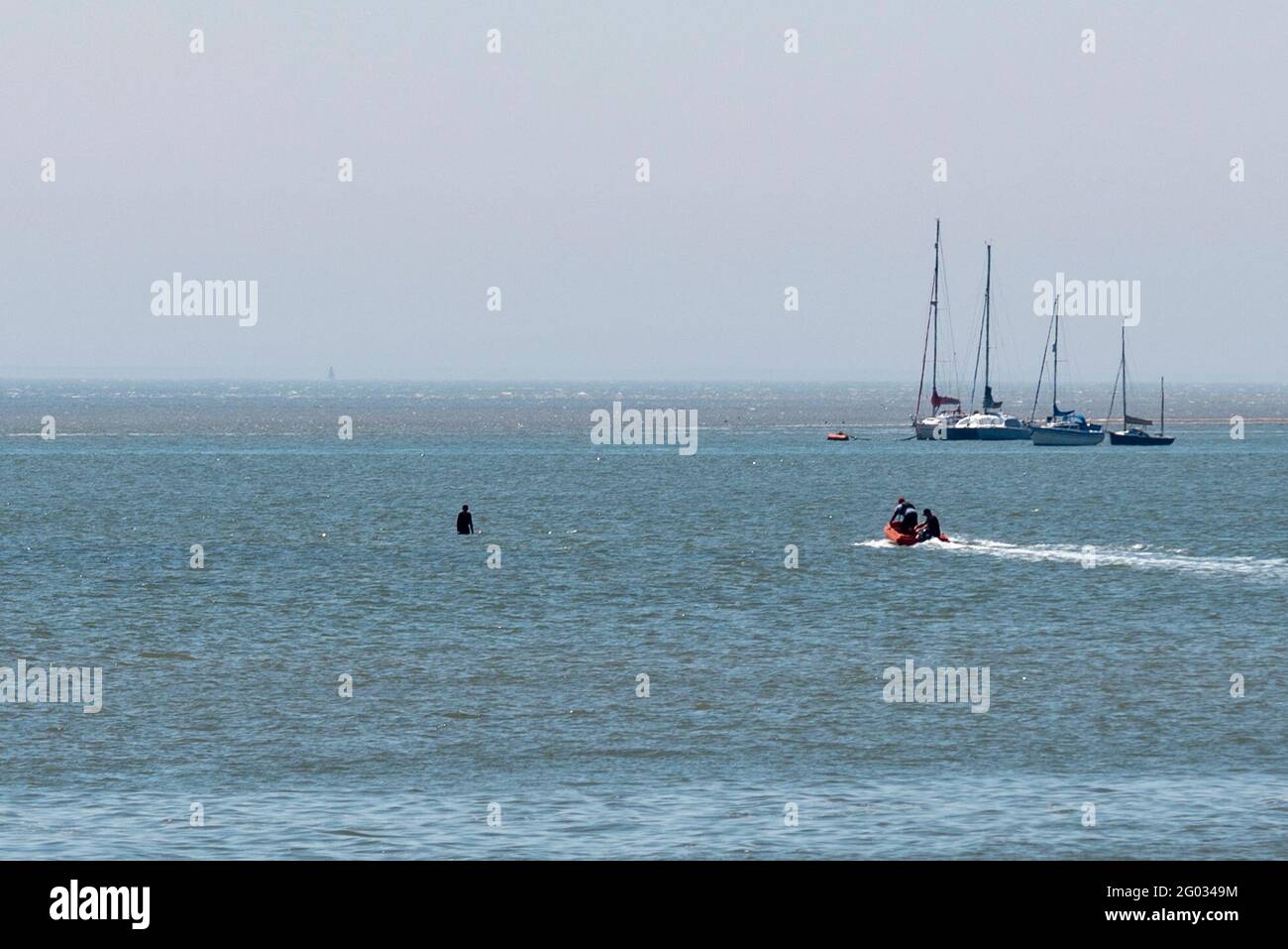 Southend on Sea, Essex, UK. 31st May, 2021. The warm sunny weather has attracted people to the seaside town on Bank Holiday Monday. A young male was caught out by the incoming tide resulting in being picked up firstly by a local boat then transferred to the RNLI hovercraft Stock Photo